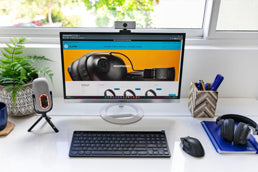 Professional using JLab work headset and desk accessories